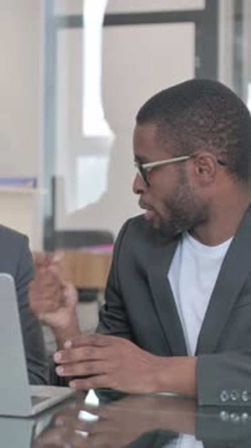 Man in Suit Discussing Business at Meeting Table