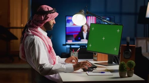 Man Working at Computer at Night