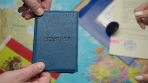 During Spanish Citizenship Ceremony Hands Transfer Passport to Recipient with Schengen Papers