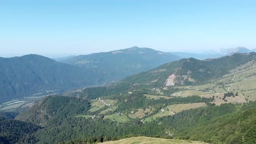aerial view of mountain pastures in slovenia countryside on sunny summer day