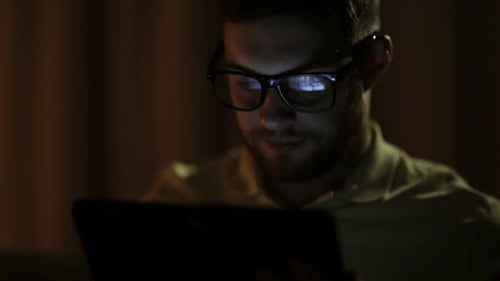Technology, Internet, Communication and People Concept - Young Man in Glasses With