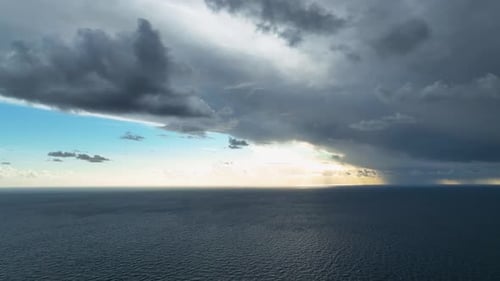 Epic Cinematic Flight Over Awesome Deep Blue Sea with Scenic White Clouds in Blue Sky