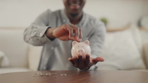 Happy African Man Saving Up Money for Dream Closeup of Hands with Piggy Bank Young Adult Black Male