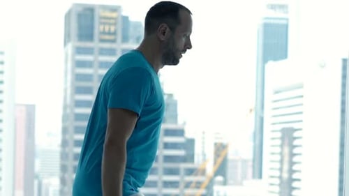 Sporty Man Exercising With Skipping Rope By Window In Gym