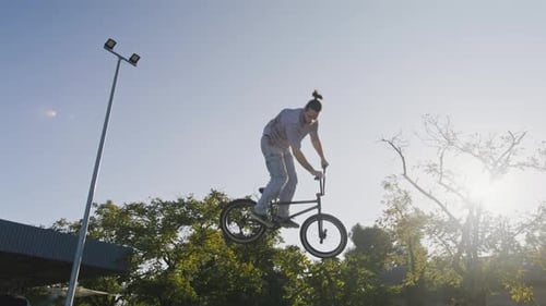Skilled Bmx Rider Performing Aerial Trick in Skate Park