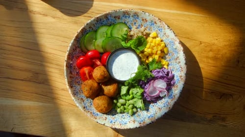 Delicious Vegan Falafel Bowl on Wooden Table