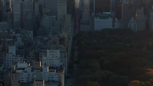 Aerial Views Capture Cars Moving Through 5Th Avenue Next to Central Park Showcasing Vibrant Urban