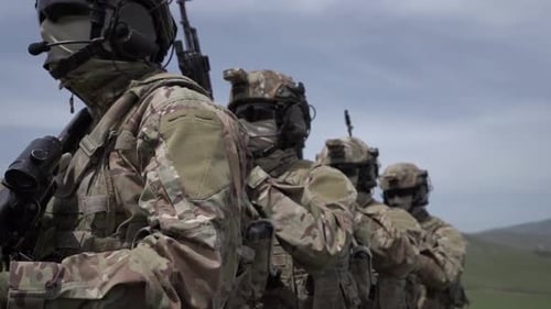 Soldiers Standing with Rifles in Grassy Field