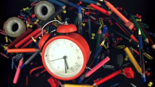 Alarm Clock and School Supplies Fly and Fall Filmed on a Highspeed Camera at 1000 Fps
