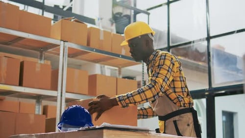 Warehouse Workers Packaging Boxes for Shipment