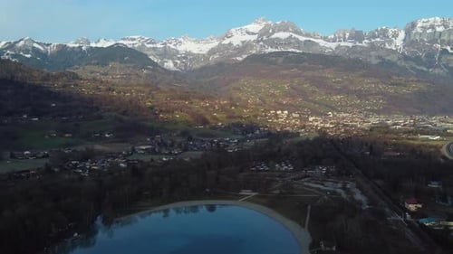 Aerial panning over the Arve valley, town of Sallanches and Passy lake. French Alps early in the mor