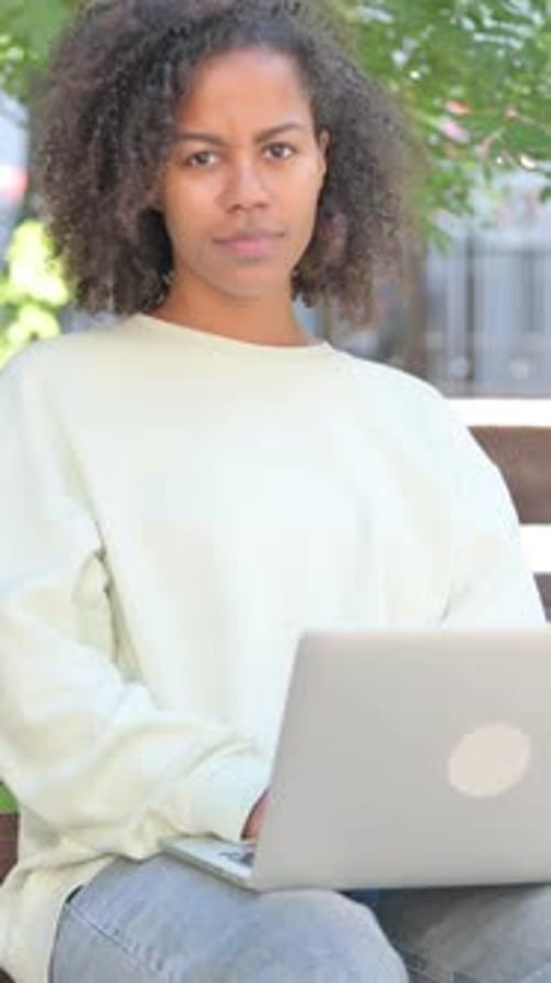 Young Woman Working on Laptop Outdoors Smiling Portrait
