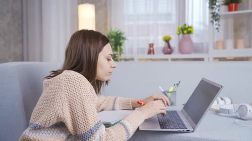 Young college student girl learning and learning remotely online using laptop.