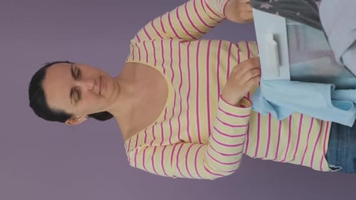 Woman Folding Laundry Indoors