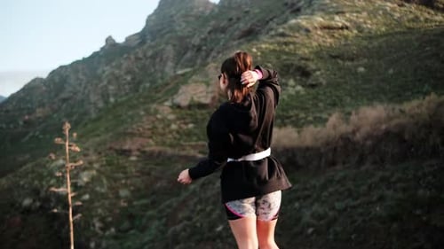 Woman Stretching Before Exercise in Tropical Mountains