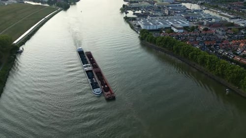 Cargo ship with coal bulk load on the Binnen-Merwede river in Sliedrecht, Netherlands. Aerial