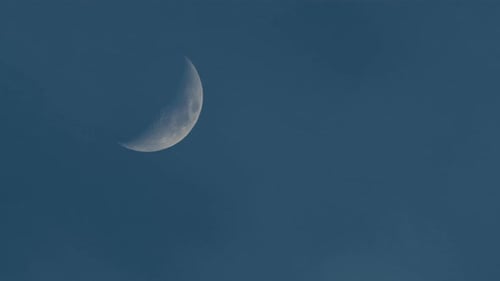Waxing Crescent Moon Slowly Moving Through Night Sky