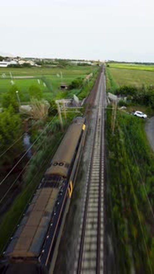 Aerial View of Train Traveling Through Rural Landscape