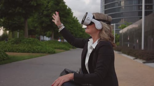 Woman Interacting with Virtual Reality Outdoors