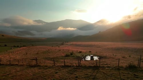 Aerial View Of Countryside Fields, Valley, And Mountains On A Foggy Sunrise In Tuscany, Italy. - sid