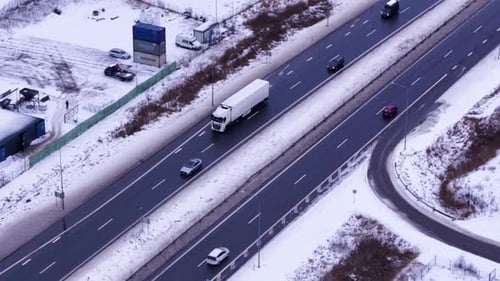 Semi truck transporting cargo in winter season, aerial drone view
