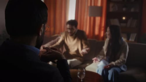 Couple Talking to Therapist in Dimly Lit Office