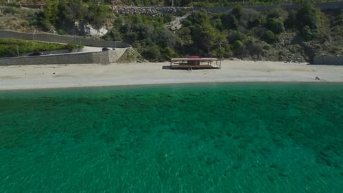 Drone View of Remote Beach with Wooden Hut By Sea