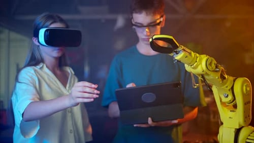 Young Woman in VR with Man and Robotic Arm