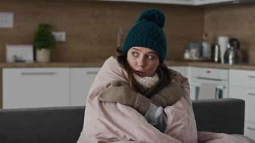 Caucasian woman wearing the warm clothes and covering the duvet. Shot with RED helium camera in 8K.