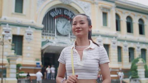 Portrait of Cheerful Asian Woman Walking in City Center