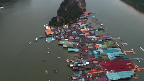 Aerial view tilting over the Koh Panyee Floating Fishing Village, in cloudy Thailand