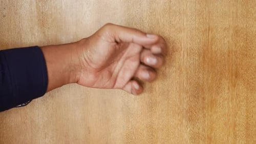 Young Man Hand Knocking Door