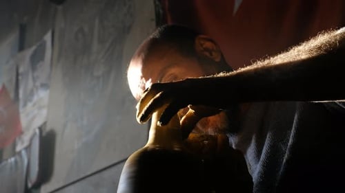 Bearded Potter Shaping Clay on Wheel in Studio