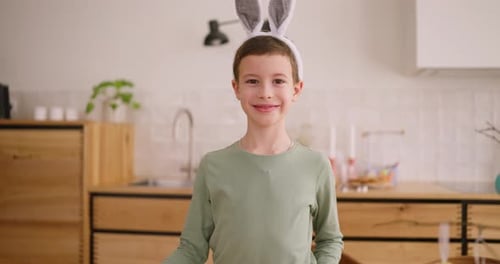 Portrait of a Boy with Bunny Ears Costume While Posing During Easter Holiday at Home