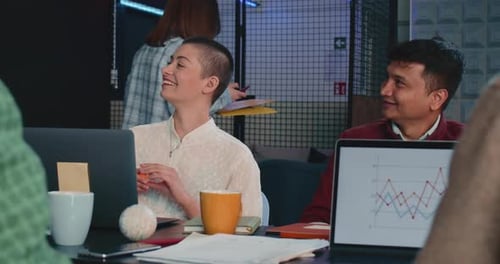 Young Happy Multiethnic Man and Woman Business People Smile Working Together at Light Office Table