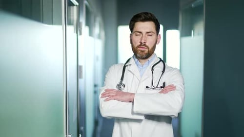 Confident Doctor with Stethoscope in Hospital Corridor