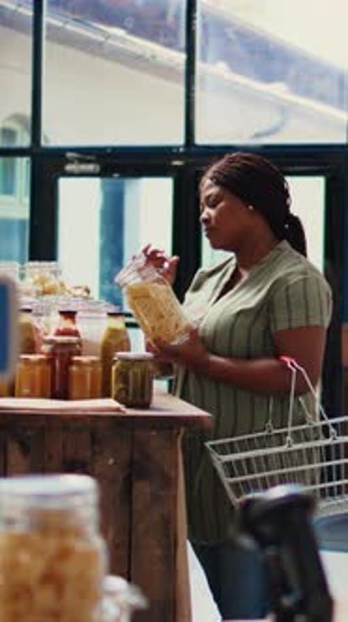 Woman Browsing Jars and Bottles in Grocery Store