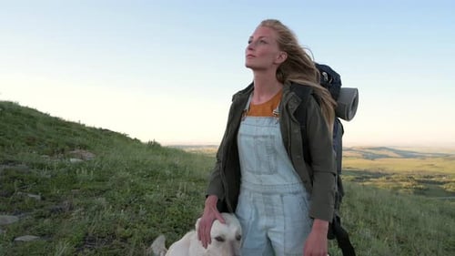 Woman Hiker and Dog Enjoying Scenic Vista