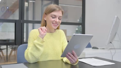 Woman Video Chatting on Tablet in Office