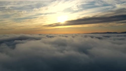 Sunset Over Sea of Clouds Moving In The Sky. - aerial timelapse