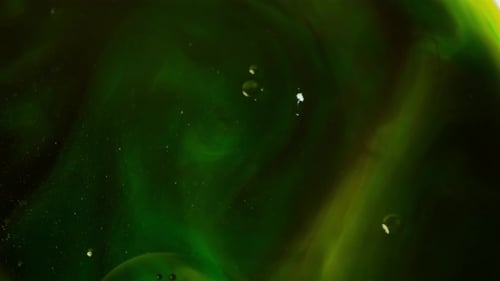 Abstract Video of Shades of Green Moving in Water and White Spots Appearing