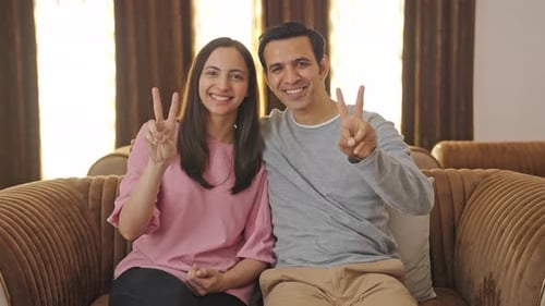 Cheerful Couple Posing on Couch at Home