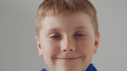 Portrait of Happy Smiling Boy in Blue Tshirt Attractive Kid in Studio Over Grey