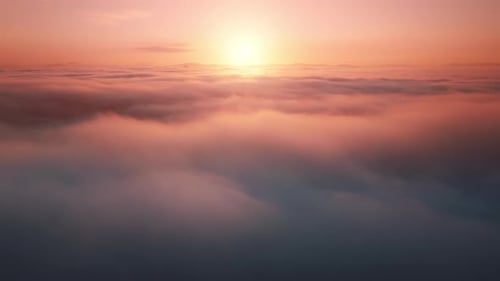 Camera is raising above the sea of endless clouds at golden sunset hour.