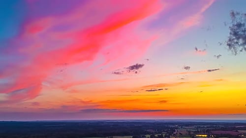 Colorful Clouds at Sunset Over Rural Landscape