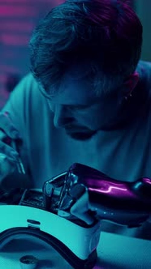 Man Repairs VR Headset with Robotic Arm