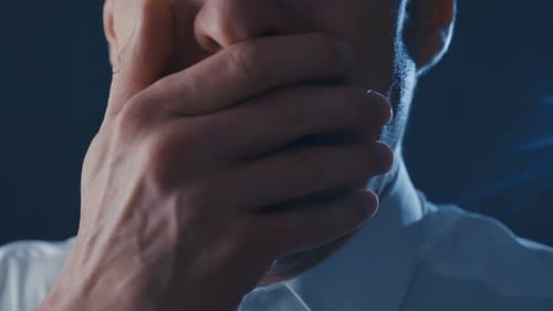 Distressed Man Covers His Face in Despair