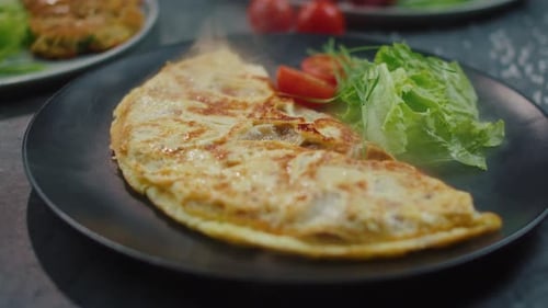 Delicious Omelet Garnished with Salad and Tomato