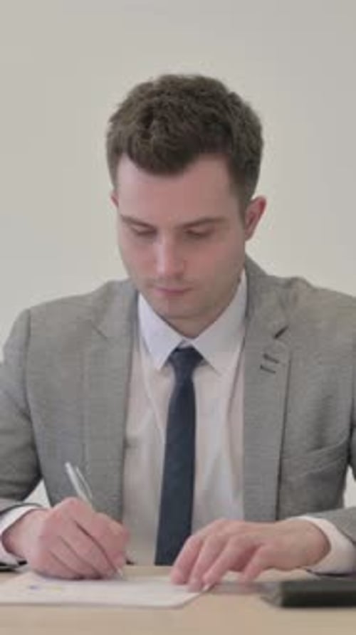 Concentrated Businessman Working at His Desk Indoors