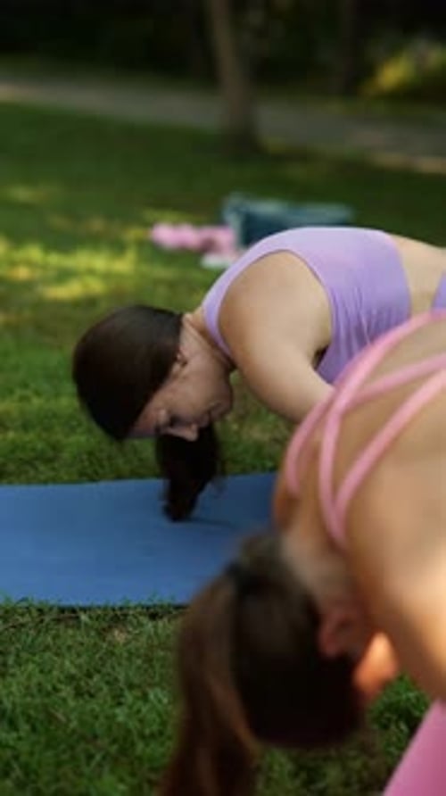 In the Summer Park a Beautiful Mother and Her Athletic Daughter are Engaging in Sports